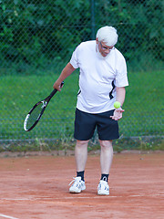 Image showing Senior man playing tennis