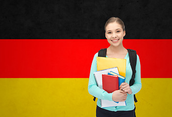 Image showing happy and smiling teenage student girl with books