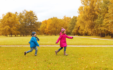 Image showing group of happy little kids running outdoors