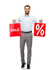 Image showing smiling man with red shopping bag