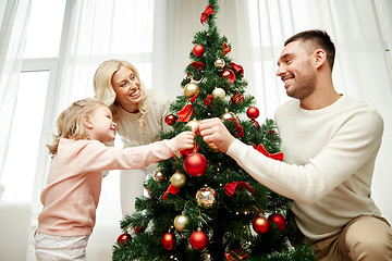 Image showing happy family decorating christmas tree at home