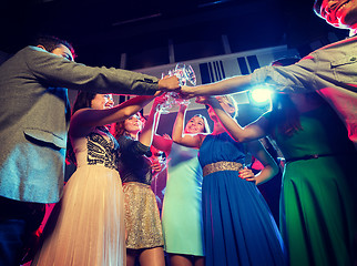 Image showing smiling friends with glasses of champagne in club