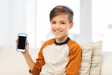 Image showing smiling boy with smartphone at home