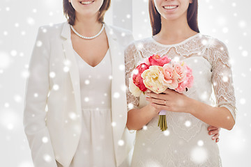 Image showing close up of happy lesbian couple with flowers