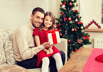 Image showing smiling father and daughter holding gift box