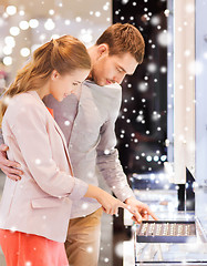 Image showing happy couple choosing engagement ring in mall