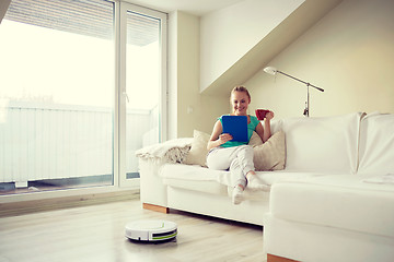 Image showing happy woman with tablet pc drinking tea at home