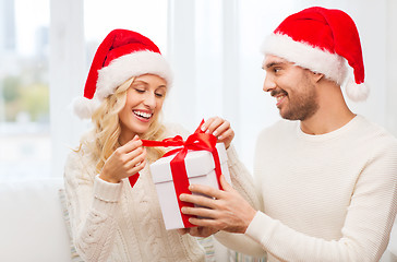 Image showing happy couple at home with christmas gift box