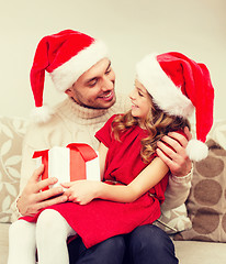 Image showing smiling father and daughter holding gift box