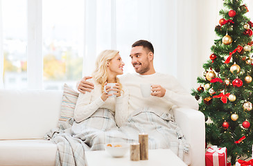 Image showing happy couple at home with christmas tree