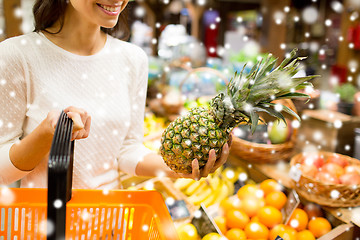 Image showing close up of woman with pineapple in grocery market