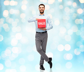 Image showing smiling man with red shopping bag