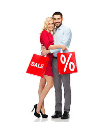 Image showing happy couple with red shopping bags