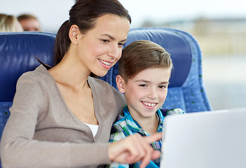 Image showing happy family with tablet pc sitting in travel bus