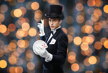 Image showing magician showing trick with playing cards