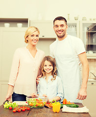 Image showing happy family making dinner in kitchen