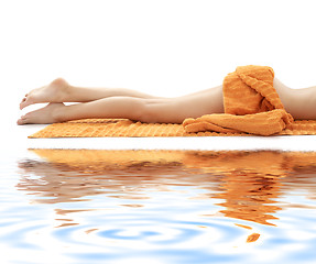 Image showing long legs of relaxed lady with orange towel on white sand #3