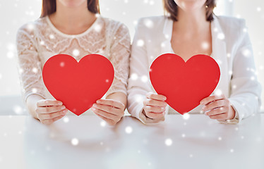 Image showing close up of happy lesbian couple with red hearts