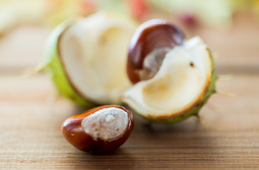 Image showing close up of chestnut on wooden table