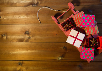 Image showing close up of christmas gift boxes on wooden sleigh