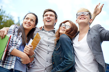 Image showing group of happy students with folders outdoors