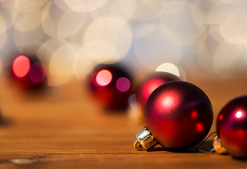 Image showing close up of red christmas balls on wood