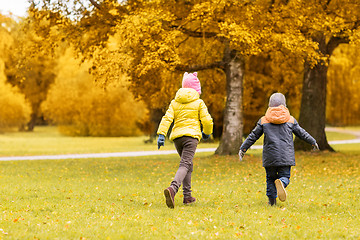 Image showing group of happy little kids running outdoors