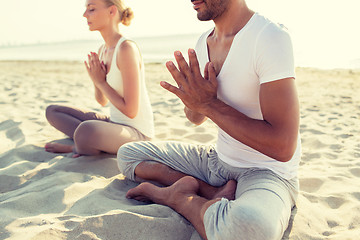 Image showing close up of couple making yoga exercises outdoors