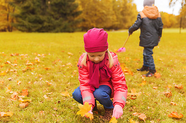 Image showing children collecting leaves in autumn park