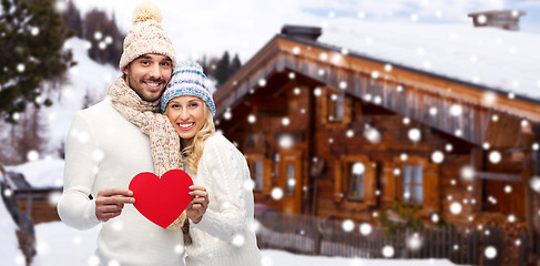 Image showing happy couple in winter clothes with heart outdoors