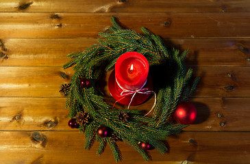 Image showing fir branch wreath with candle on wooden table