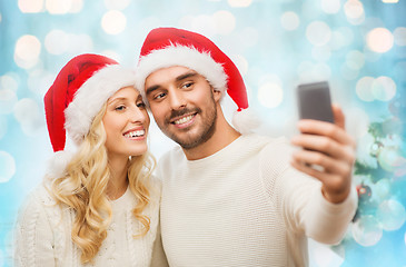 Image showing couple taking selfie with smartphone at christmas