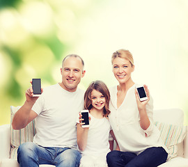 Image showing happy family with smartphones