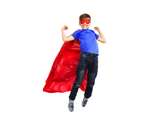 Image showing boy in red super hero cape and mask flying on air