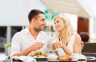 Image showing happy couple clinking glasses at restaurant lounge