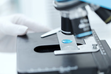 Image showing close up of scientist hand with test sample in lab