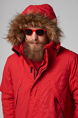 Image showing Man wearing red winter Alaska jacket  with fur hood on