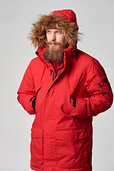 Image showing Man wearing red winter Alaska jacket  with fur hood on