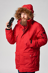 Image showing Man wearing red winter Alaska jacket  with fur hood on