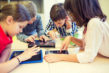 Image showing group of school kids with tablet pc in classroom