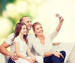 Image showing happy family with camera at home