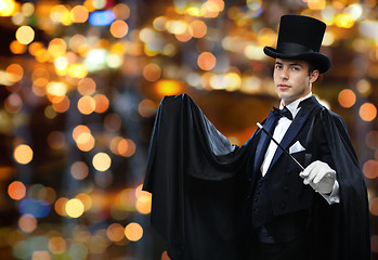 Image showing magician in top hat showing trick with magic wand