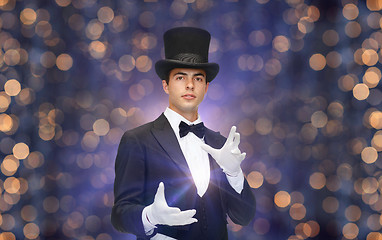 Image showing magician in top hat showing trick