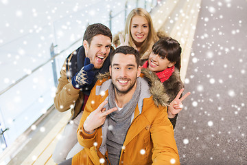 Image showing happy friends taking selfie on skating rink