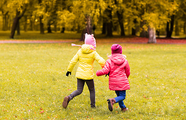 Image showing happy little girls running outdoors