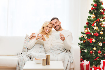 Image showing happy couple at home with christmas tree