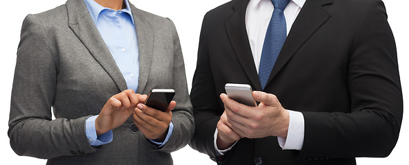 Image showing businessman and businesswoman with smartphones