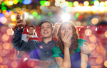 Image showing happy friends watching movie in theater