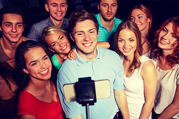 Image showing friends with smartphone taking selfie in club