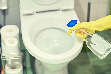 Image showing close up of hand with detergent cleaning toilet